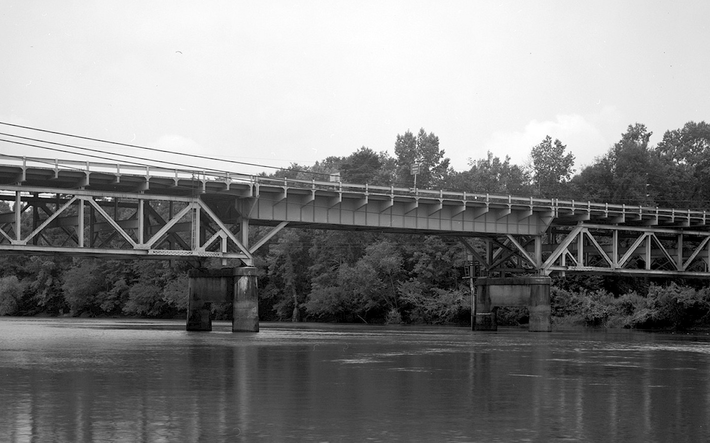 A black and white photo of a train tracks over the Choctawhatchee River, in Caryville. The tracks connect Washington and Holmes County, and across the panhandle of Florida from Pensacola to Jacksonville.